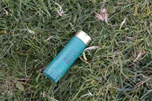 Gamebird Prints: Empty 12 bore shotgun cartridge on ground after gamebird shoot, England, November