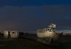 Shingle Prints: Abandoned fishing boat and fisherman hut on shingle beach at night