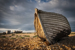 Shore Prints: Abandoned fishing boats on shingle beach, Dungeness, Kent, England, April