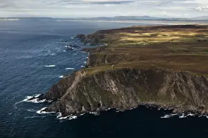 Monument Prints: Aerial view of coastline with cliffs and commemorative monument