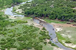 Camps Prints: Aerial view of river, African Elephants (Loxodonta africana) and tourist lodge