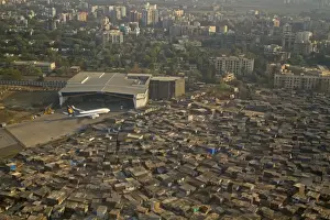 : Aerial view of slum areas surrounded by luxury apartments