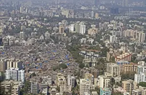 : Aerial view of slum areas surrounded by luxury apartments and offices, India, February