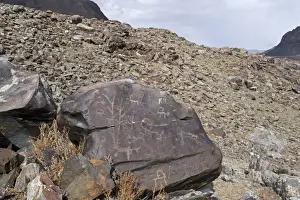 Carving Prints: Ancient petroglyphs depicting animals and humans hunting