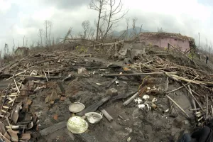 Javan Prints: Ash covered debris, dead trees and damaged house