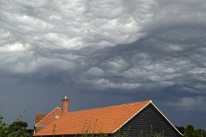 Storm Prints: Asperatus clouds and stormclouds over rooftops, Bentley, Suffolk, England, August