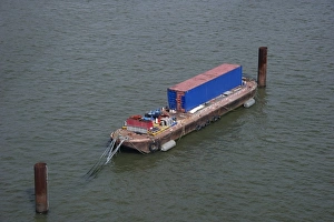 Industry Prints: Barge with container moored on river in city, River Thames, London, England, april