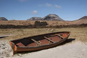 Sand Prints: Beached rowing boat at Traigh na Mile beach with the Paps of Jura behind