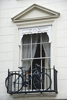 Window Prints: Bicycle on small balcony of city building, London, England, april