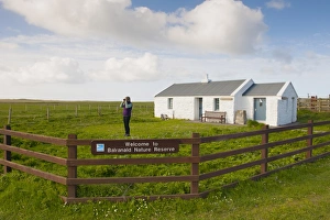Fence Prints: Birdwatcher beside visitor centre in coastal farmland