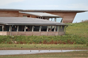 Birdwatchers in hide beside screen, Titchwell RSPB Reserve, Norfolk, England, September