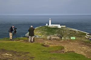 Seabird Prints: Birdwatchers using spotting scopes to view nesting seabirds on cliffs