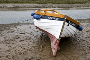 Mud Flats Prints: Boat moored on mud at edge of coastal creek, Blakeney, Norfolk, England, may