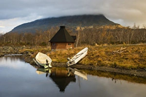 Northern Europe Prints: Boats moored on lake shore with Kota (hut)