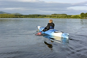 : Boy kayaking on reservoir, Killington Lake, Killington Beck, Cumbria, England, June