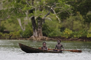 Canoe Prints: Two boys paddling dugout canoe, Kolombangara Island, Solomon Islands, April