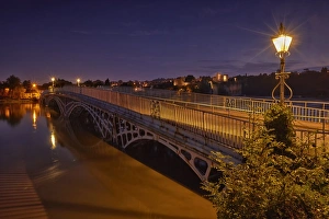 Tide Prints: Bridge over river during high tide at twilight