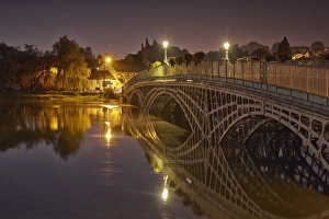 Tide Prints: Bridge over river during high tide at twilight