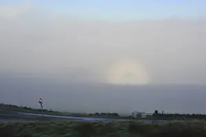 Brocken spectre seen from hilltop, appears when sun shines from behind person who is looking down from ridge or peak into mist or fog, Jeffrey Hill, Longridge, Lancashire, England, january