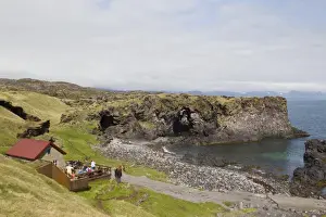 Visit Prints: Cafe with tourists beside cove, Hellnar, Snaefellsness Peninsula, Iceland, June