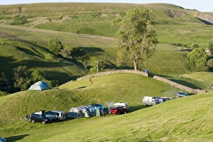 : Campsite with campervans and tents on farmland in evening, Swaledale, Yorkshire Dales N. P
