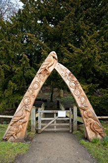 Carved wooden archway at entrance to woodland, Crow Wood, Danby, North York Moors N. P. North Yorkshire, England, March