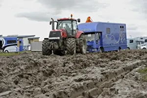 Vehicle Prints: Case tractor pulling horse lorry out of muddy carpark at agricultural show