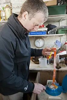 Genetics Prints: Cattle farming, farmer taking frozen bull semen from flask of liquid nitrogen