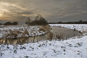 Wintery Prints: Chalk stream with snow covered banks in early evening, Dorset, Englnad, december