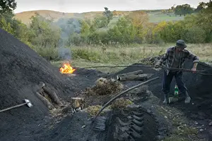 Rumania Prints: Charcoal burning, charcoal burner lighting pile in traditional yard