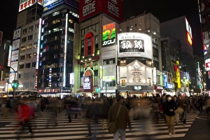 Town Prints: City street with people and illuminated advertising on buildings at night