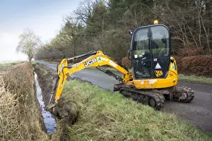 : Cleaning out roadside drainage ditches which had become overgrown using JCB digger