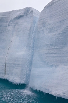 Coastal glacier terminus with waterfall from melting ice, Brasvellbreen Glacier, Nordaustlandet, Svalbard, august