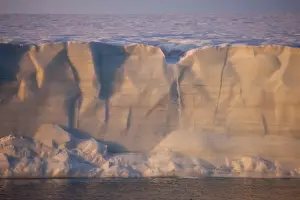 North Polar Prints: Coastal glacier terminus with waterfall from melting ice at sunset