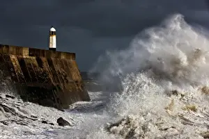 Trending: Coastal resort town seafront and lighthouse bombarded by waves during storm