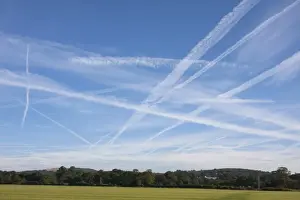 Trail Prints: Condensation trails in sky, artificial clouds formed behind aircraft