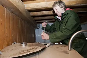 Tank Prints: Dairy farming, woman from National Milk Records taking sample from bulk milk tank