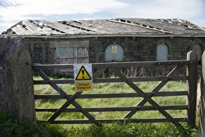 Dangerous Prints: Danger, Keep out sign on gate and derelict farm building, Lancashire, England, April