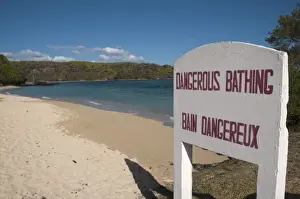 Dangerous Prints: Dangerous Bathing, Bain Dangereux bilingual sign on sandy beach, Southwest Mauritius