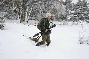 Shot Prints: Deer stalker walking in snow with shot Western Roe Deer