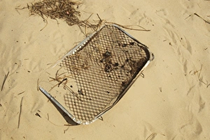 Pollution Prints: Disposable barbeque, litter on coastal sand dune, Studland, Dorset, England, may