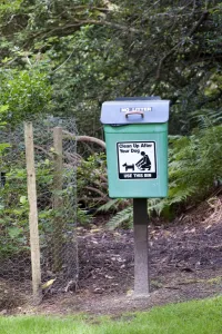 Dropping Prints: Domestic Dog, dog waste bin, in countryside park, England, august