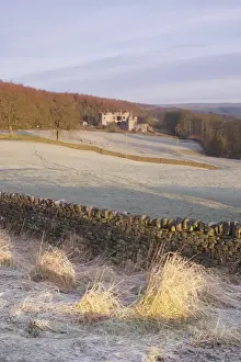 Drystone wall and frosted grasses, with remains of 15th Century hunting lodge in distance, Barden Tower, Barden