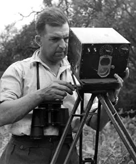 Photography Prints: Eric Hosking setting up an automatic trip for use with High Speed Flash to Photograph birds in flight -1948