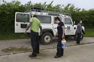 Eurasian Badger (Meles meles) bovine tuberculosis vaccination scheme, Wildlife Trust personnel being sprayed with
