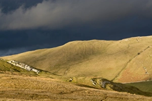 Moorland Prints: Evening sunlight on fells with stormclouds behind