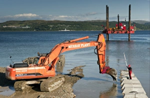 Excavator building sea defences, Dunoon, Firth of Clyde, Argyll and Bute, Scotland, august