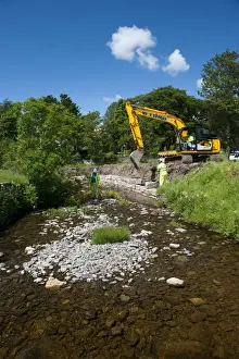 Protects Prints: Excavator improving stream bank to help prevent flooding, Cumbria, England, june