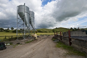 Farmyards Prints: Farmyard with two bulk feed hoppers for animal feed, Yorkshire, England, August