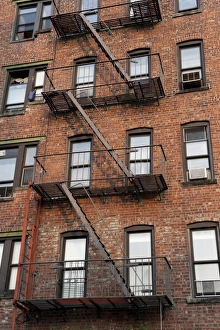 Ladders Prints: Fire escape ladders on side of brick apartment buildings